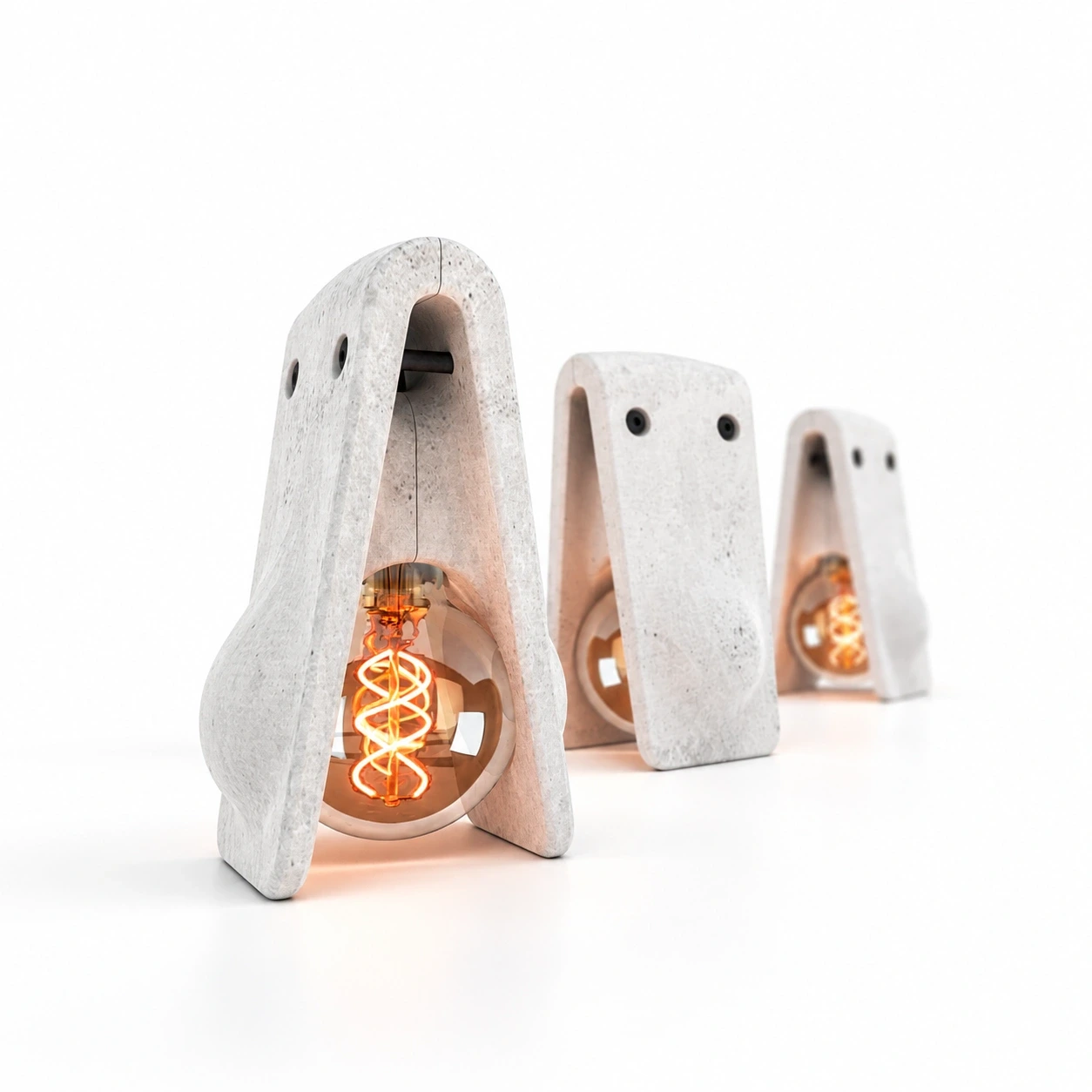 Trois lampes Jusa en béton brut sur fond blanc